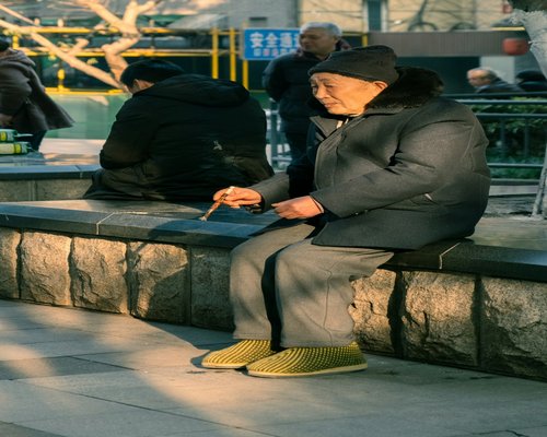 Person tying running shoes in park
